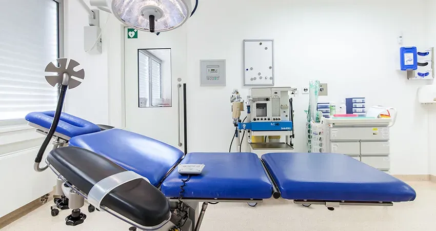 Procedure room with a treatment chair and surgical light